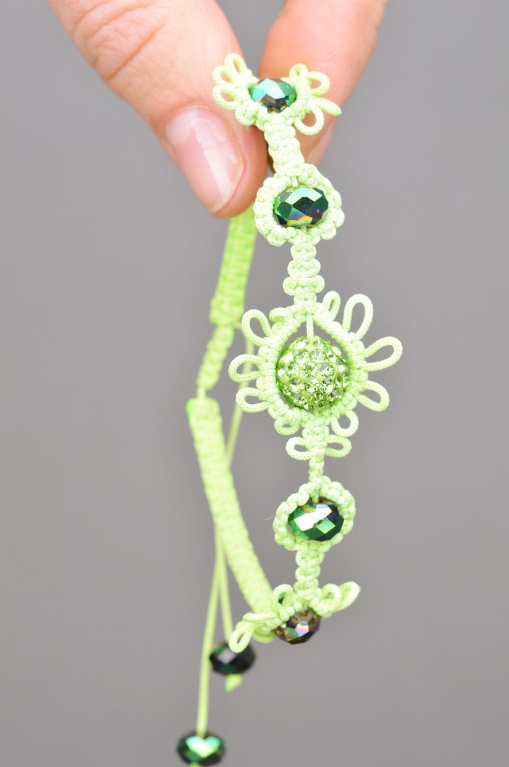 Stylish handmade women's wrist bracelet woven of threads and beads of lime color photo 3