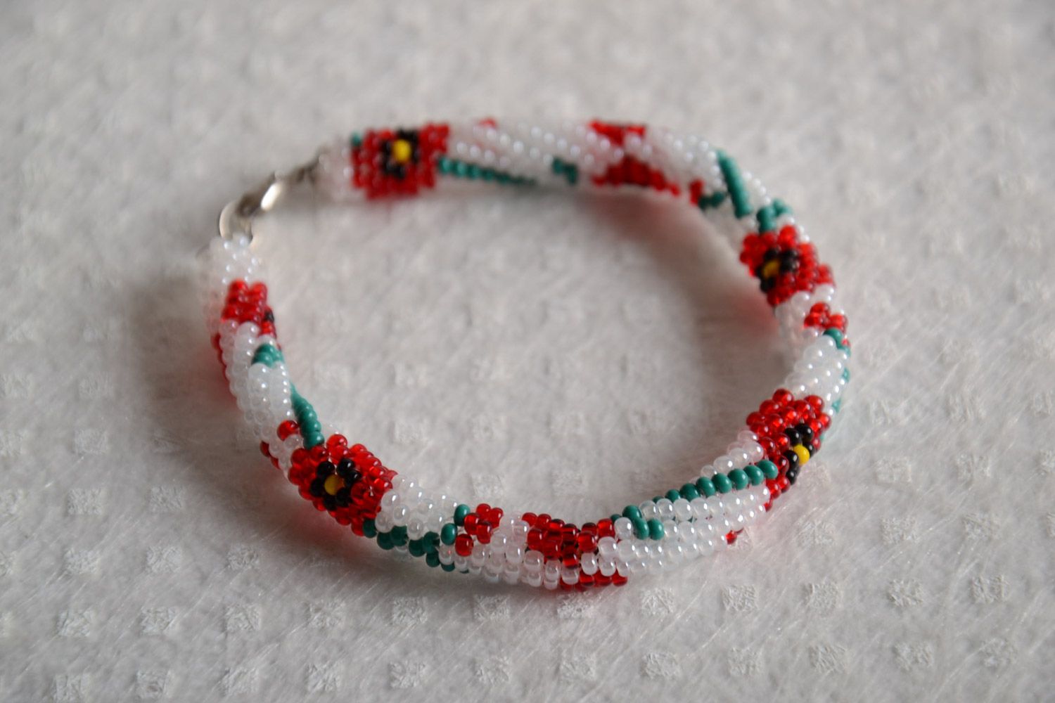 Festive white handmade beaded cord bracelet with floral motives photo 1