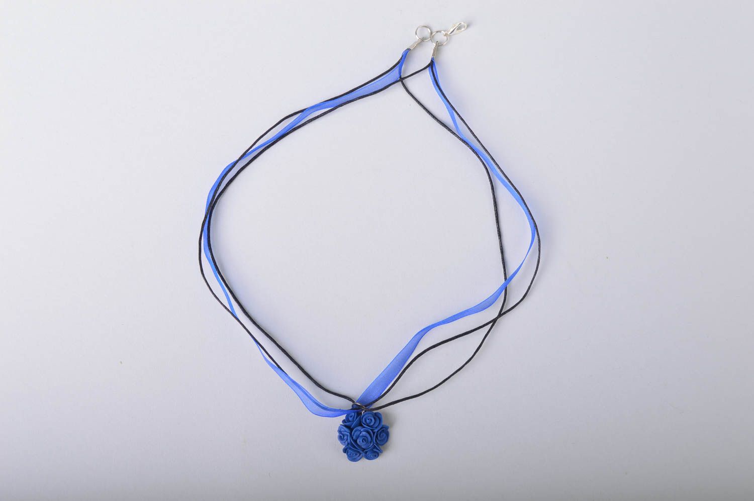 Handmade small floral deep blue cold porcelain pendant on ribbon and cord photo 2