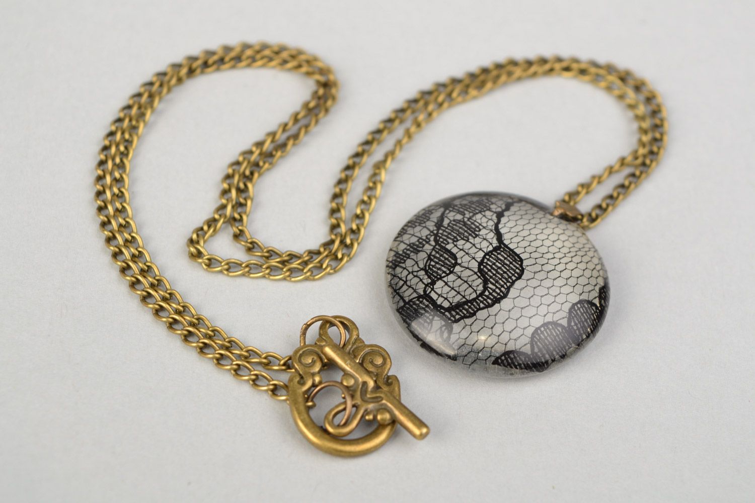 Beautiful women's round pendant on chain with epoxy coating photo 1