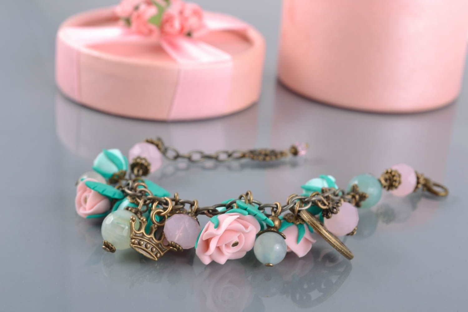 Charm bracelet with pink and turquoise roses and bronze charms photo 2