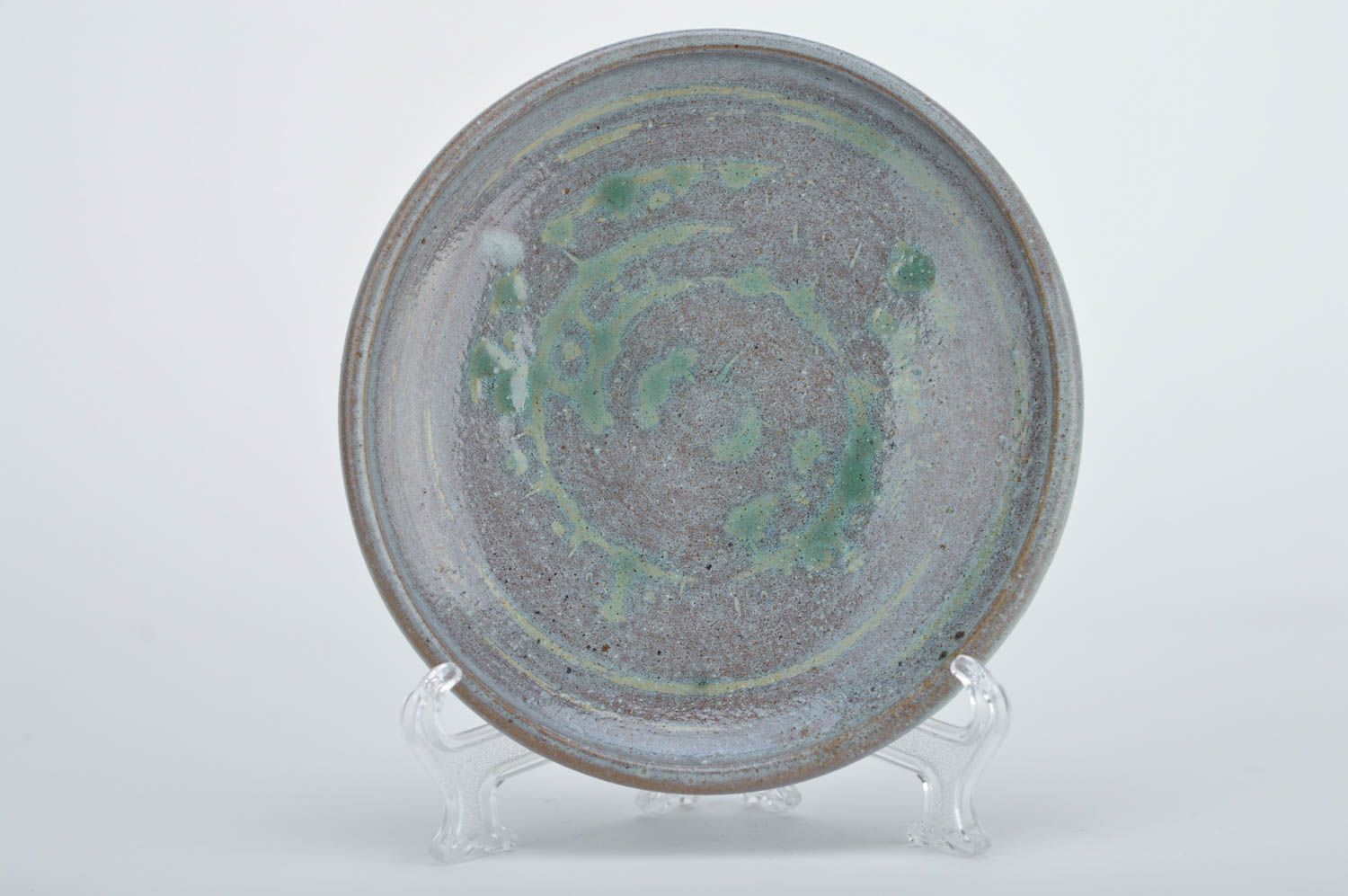 Handmade decorative round ceramic plate coated with glaze in blue green colors photo 1