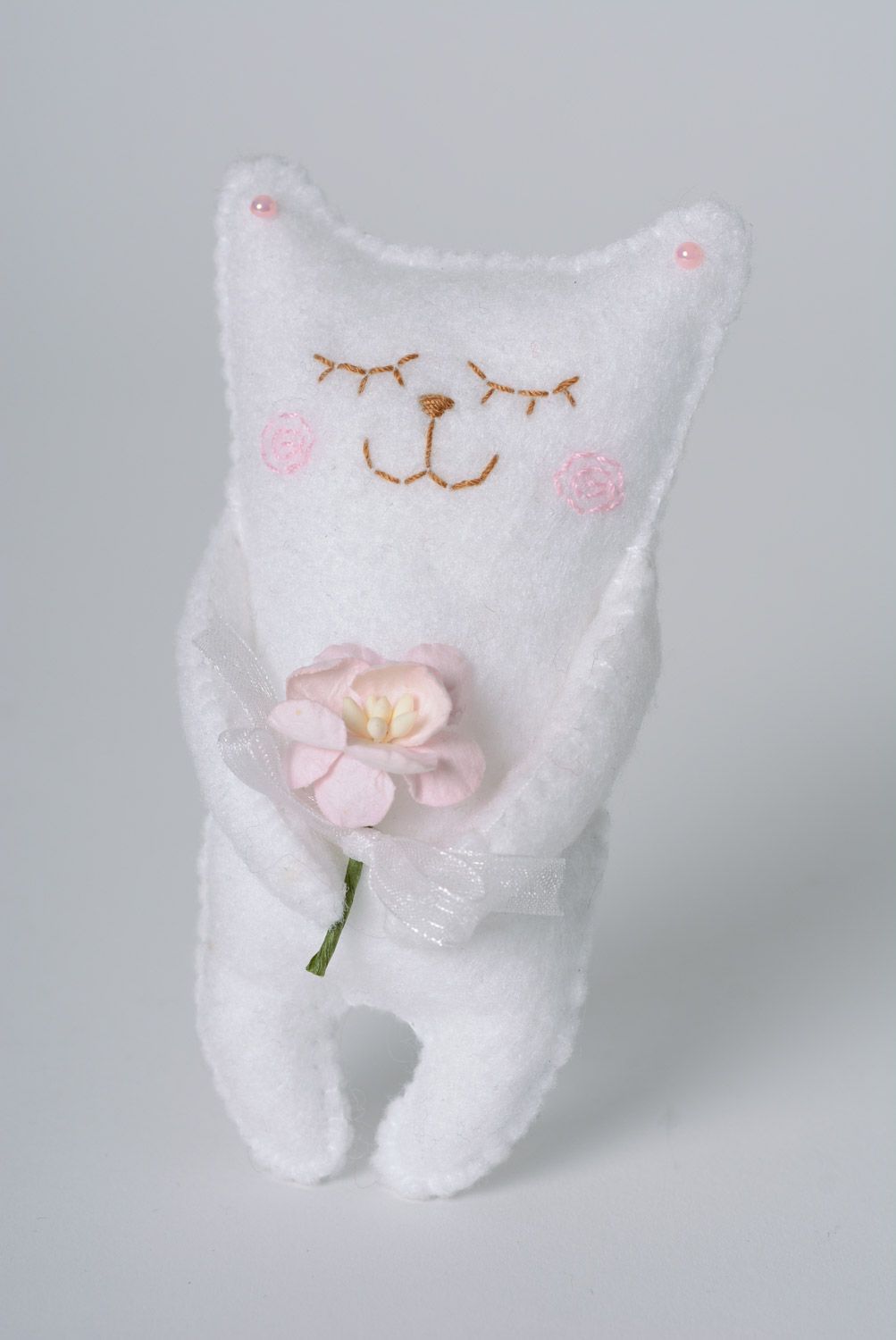 Handmade decorative designer soft toy made of felt white cat with a cute little flower photo 1