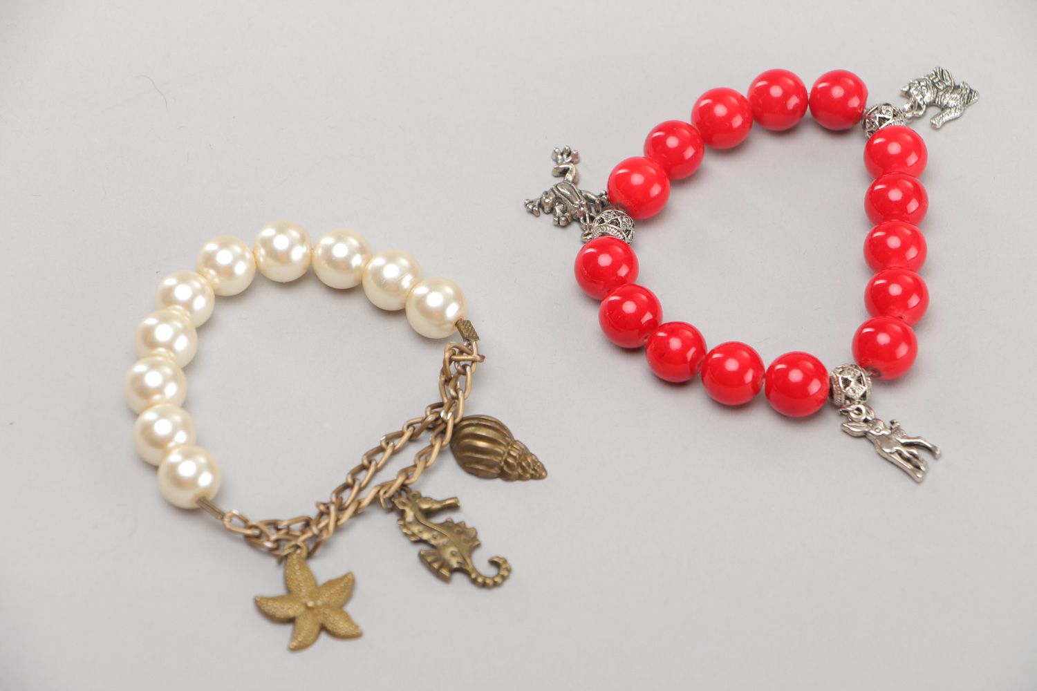 Designer handmade wrist bracelets with red beads and metal charms 2 items photo 2
