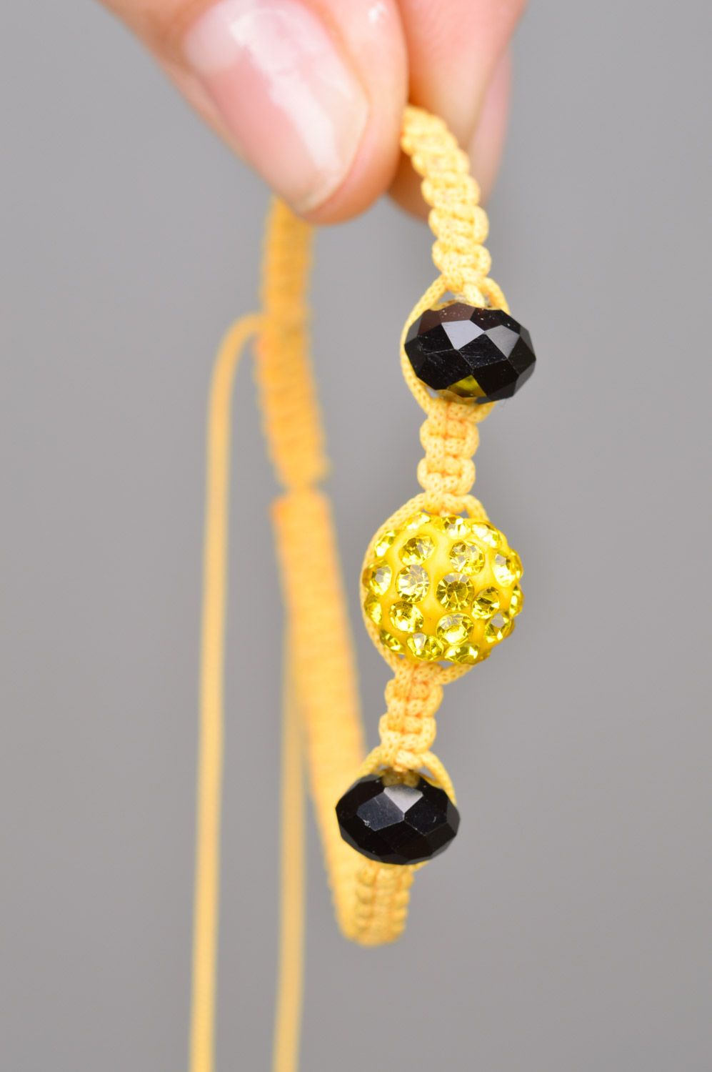 Stylish gentle handmade wrist bracelet woven of yellow threads and black beads photo 3