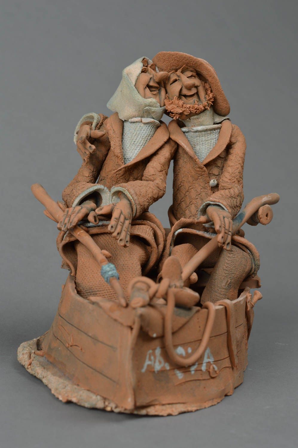 Handmade decorative unusual clay sculpture Cheerful couple in a boat photo 2