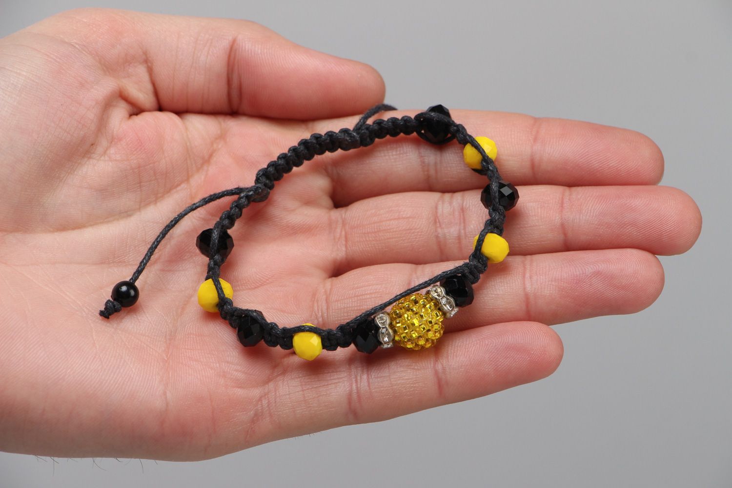 Handmade friendship bracelet woven of black cord and yellow beads for women photo 3