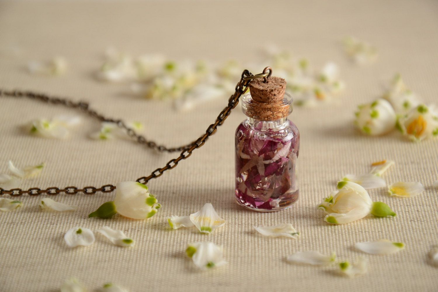 Handmade epoxy resin neck pendant with real flowers inside in the shape of transparent vial photo 1