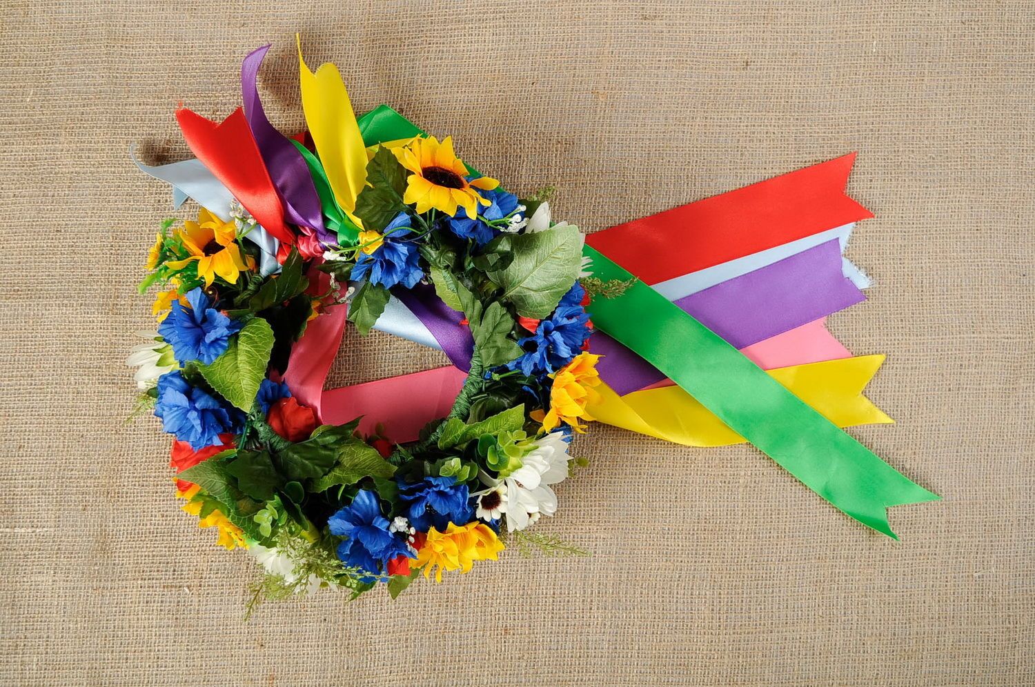 Wreath with artificial flowers and ribbons photo 2
