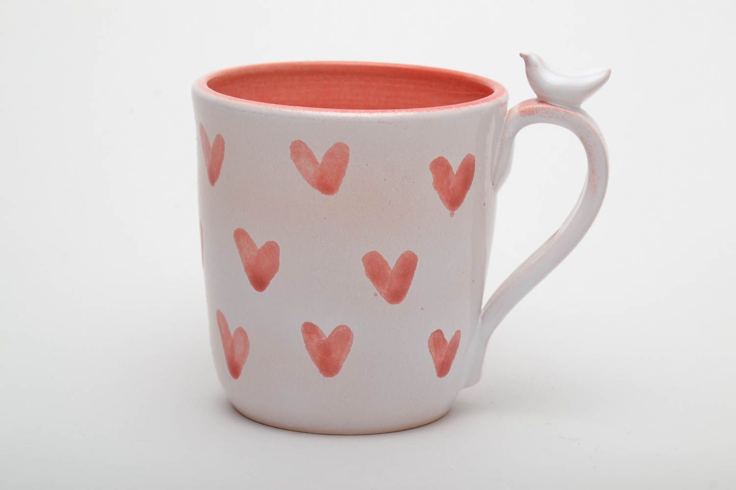 Ceramic handmade coffee cup with handle in white and orange color with hearts' pattern photo 2