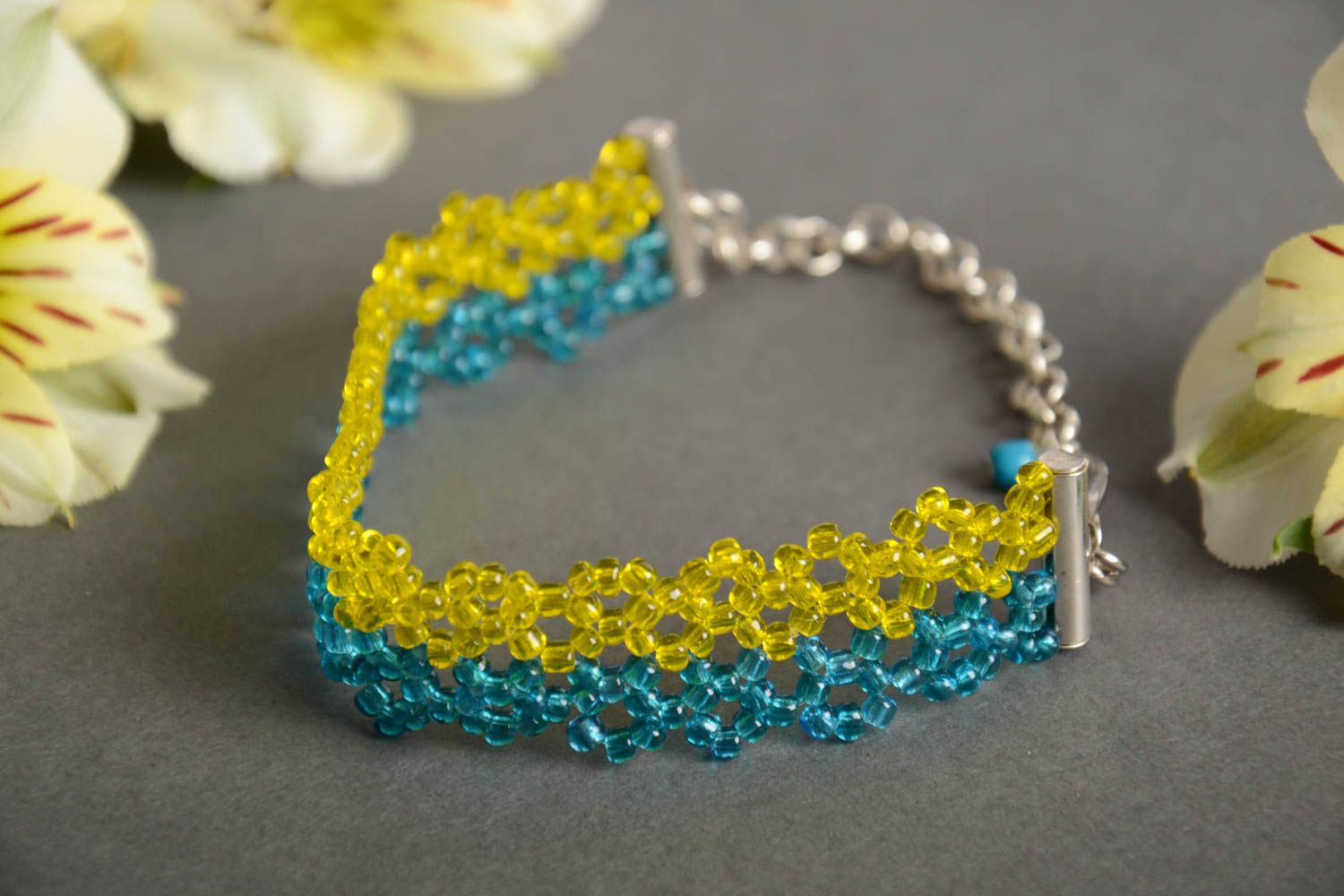 Handmade wrist bracelet crocheted of yellow and blue beads with metal chain photo 1