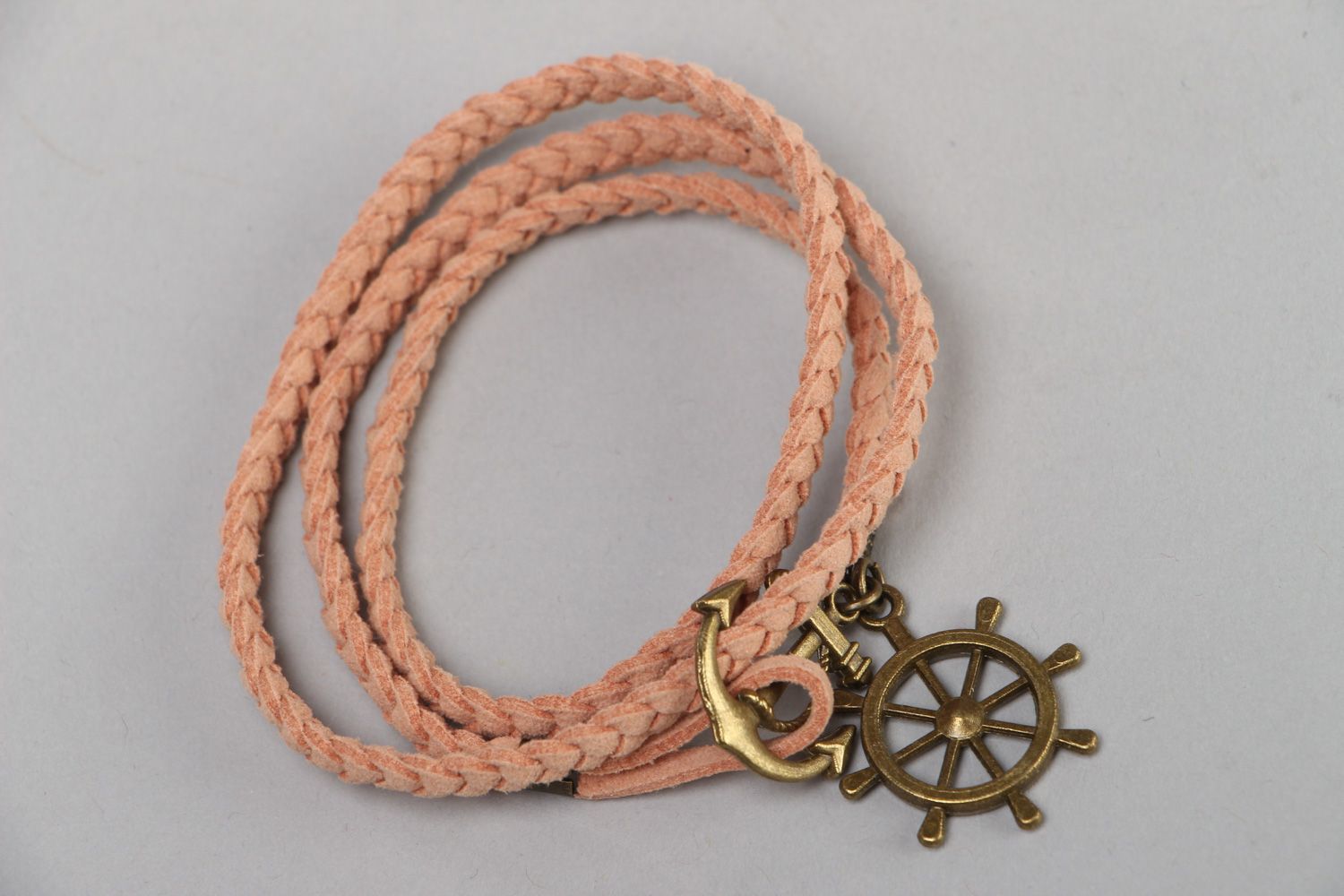 Handmade friendship bracelet woven of beige faux suede cord with steering wheel  photo 2