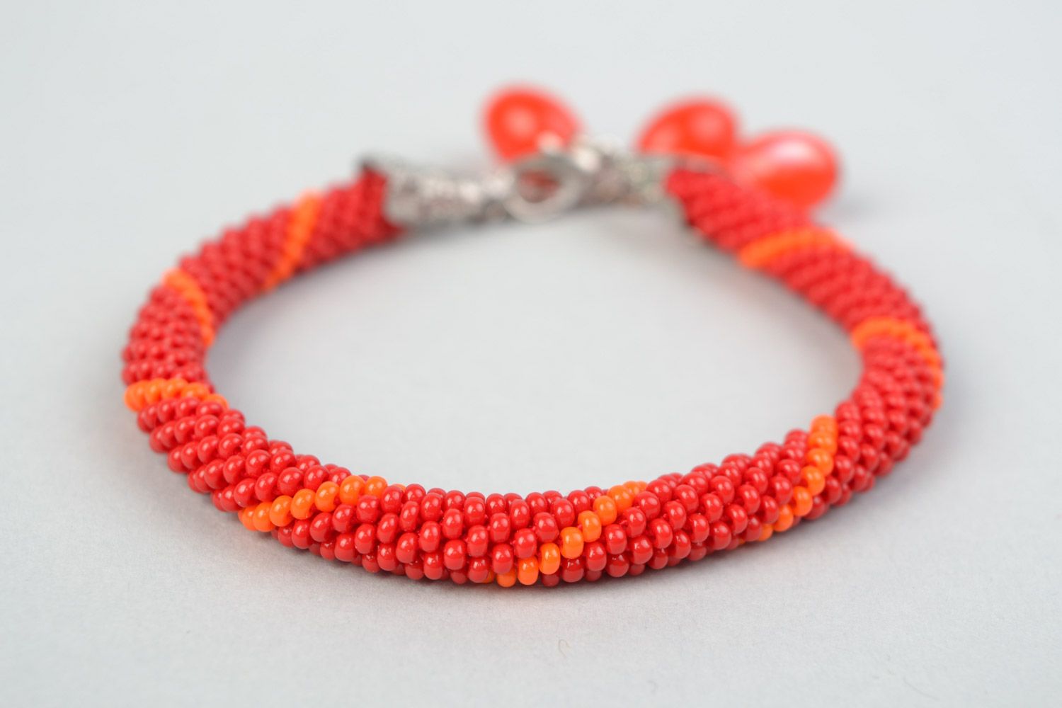 Handmade designer wrist bracelet woven of Czech beads in red color palette photo 3