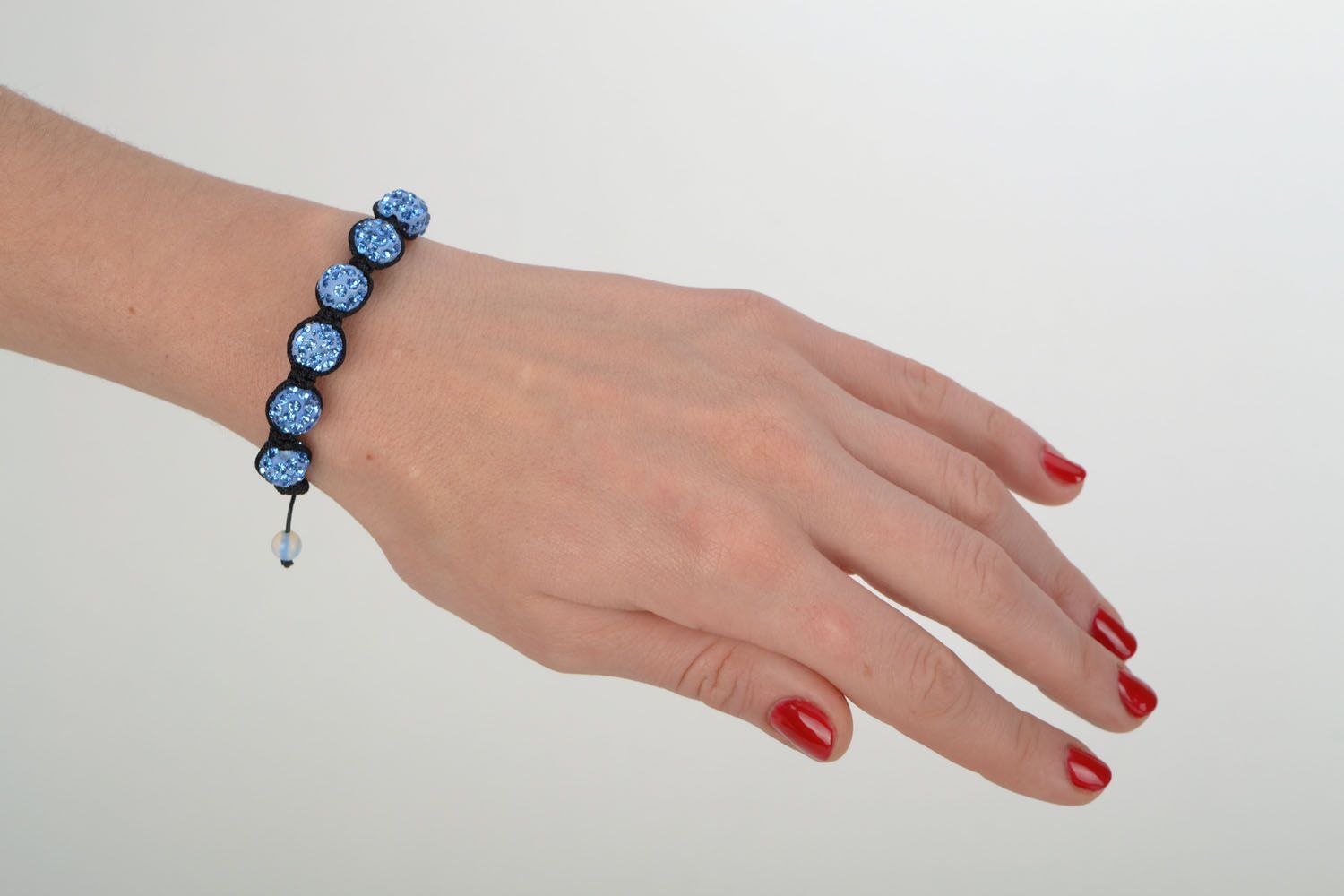 Bracelet made of blue beads and cord photo 1