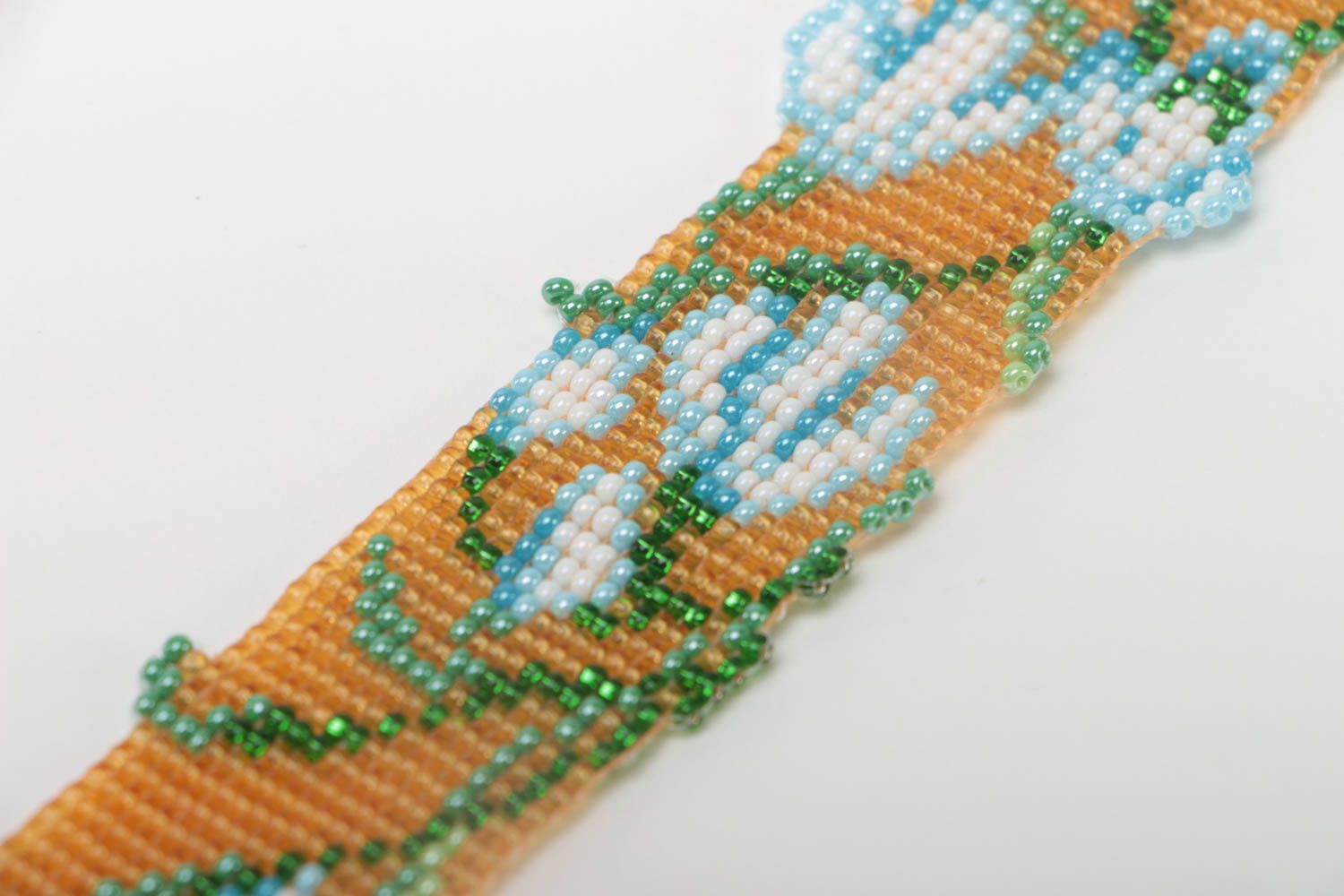 Floral ornament strand bracelet in pale orange, blue, green color for young girls photo 3