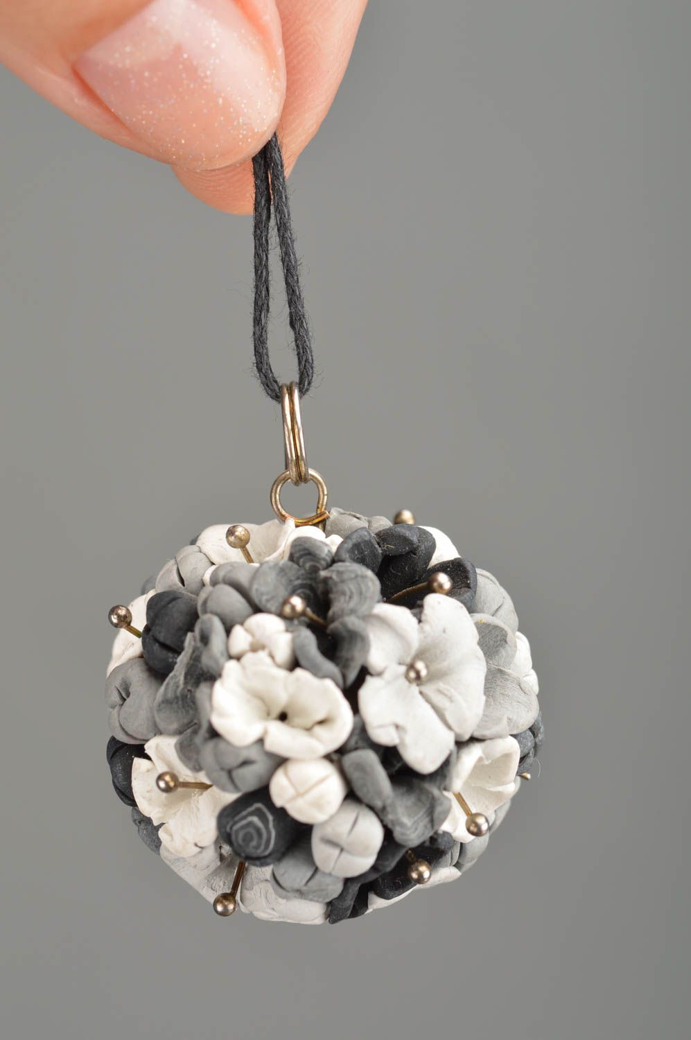 Handmade pendant made of polymer clay in form of grey flowers on cord photo 2