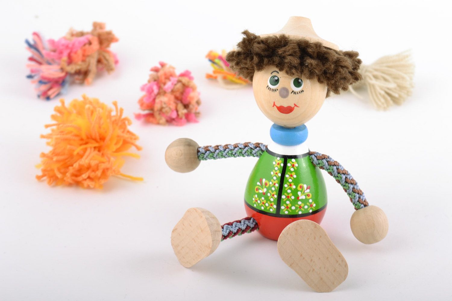 Brightly painted homemade wooden eco toy boy with hat for children and interior photo 1