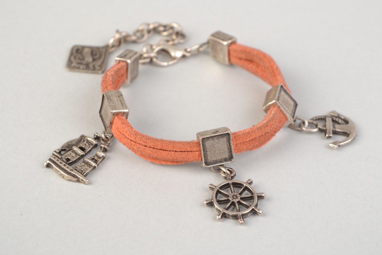 Handmade suede cord bracelet of peach color with metal charms in marine style photo 3