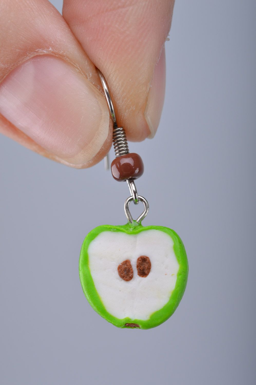 Bright lime and white handmade polymer clay earrings with charms in the shape of apple halves photo 1