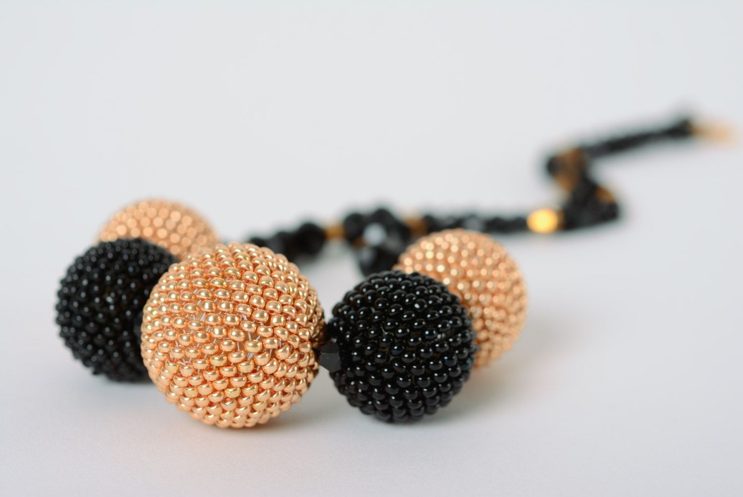 Elegant necklace with balls woven over with beige and black beads for women photo 2