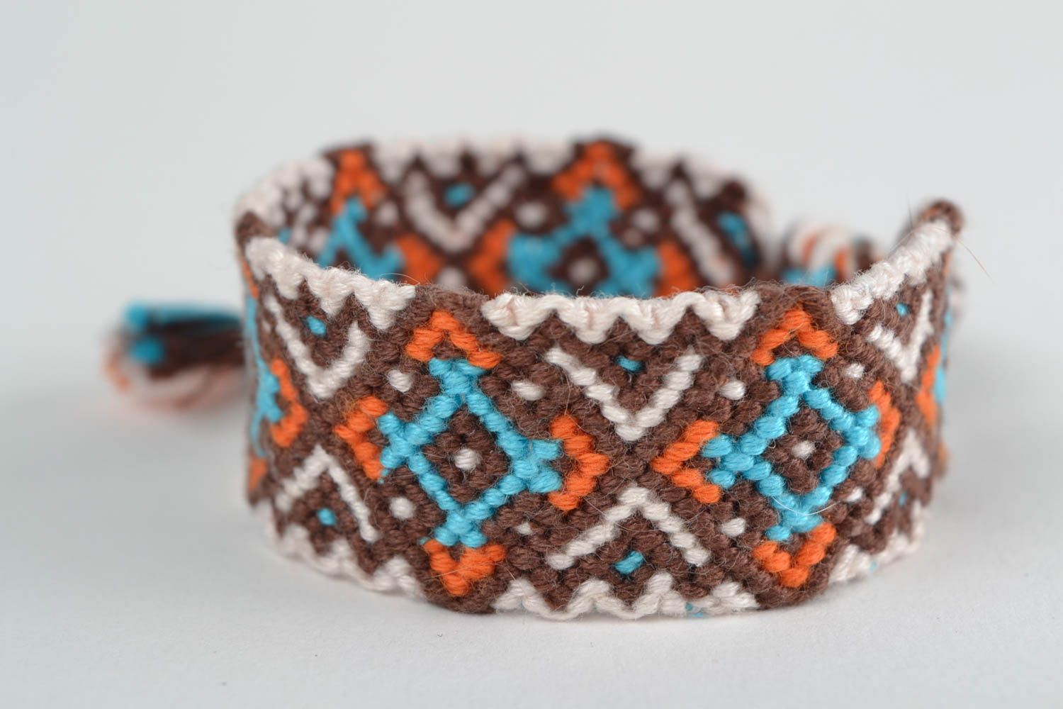 Handmade designer friendship wrist bracelet with ethnic ornament brown and blue photo 3