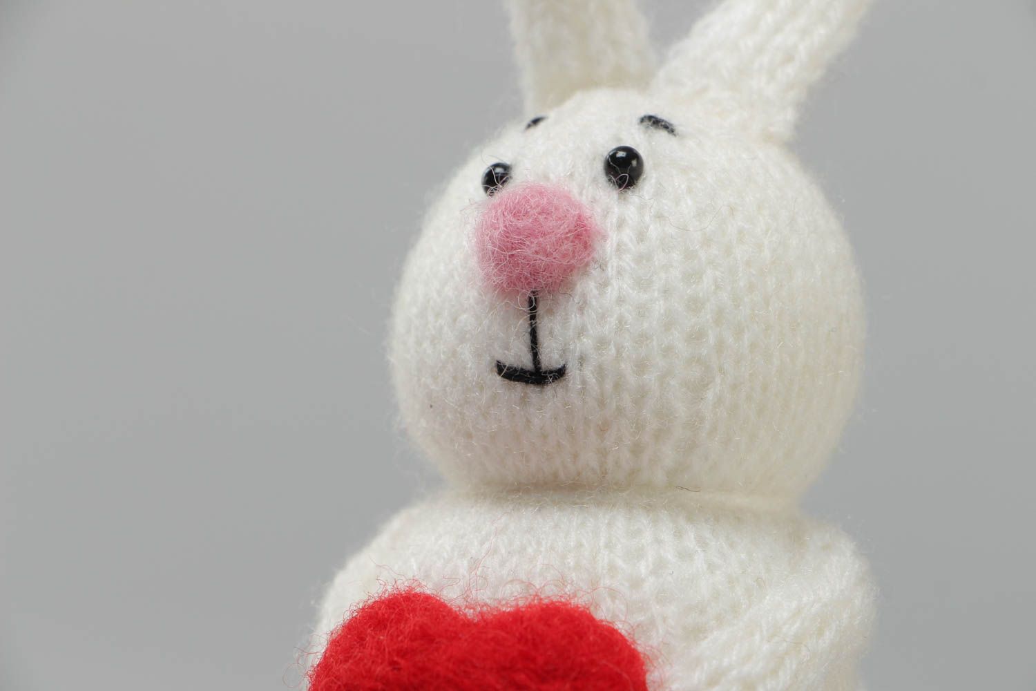 Handmade small soft toy knitted of acrylic threads white rabbit with red heart photo 3