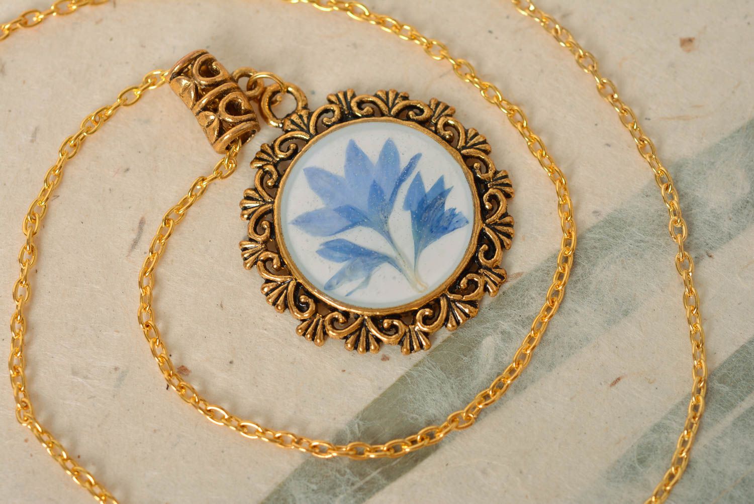 Handmade designer vintage round pendant with blue dried flower in epoxy resin photo 1