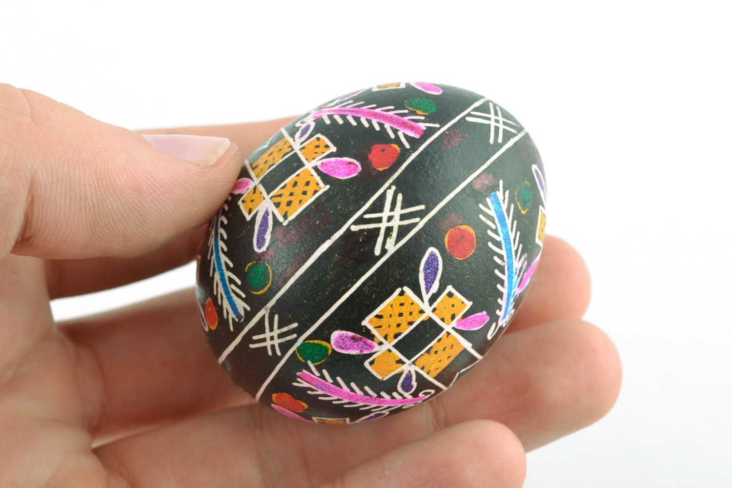 Homemade painted chicken Easter egg with cross pattern on black background  photo 2