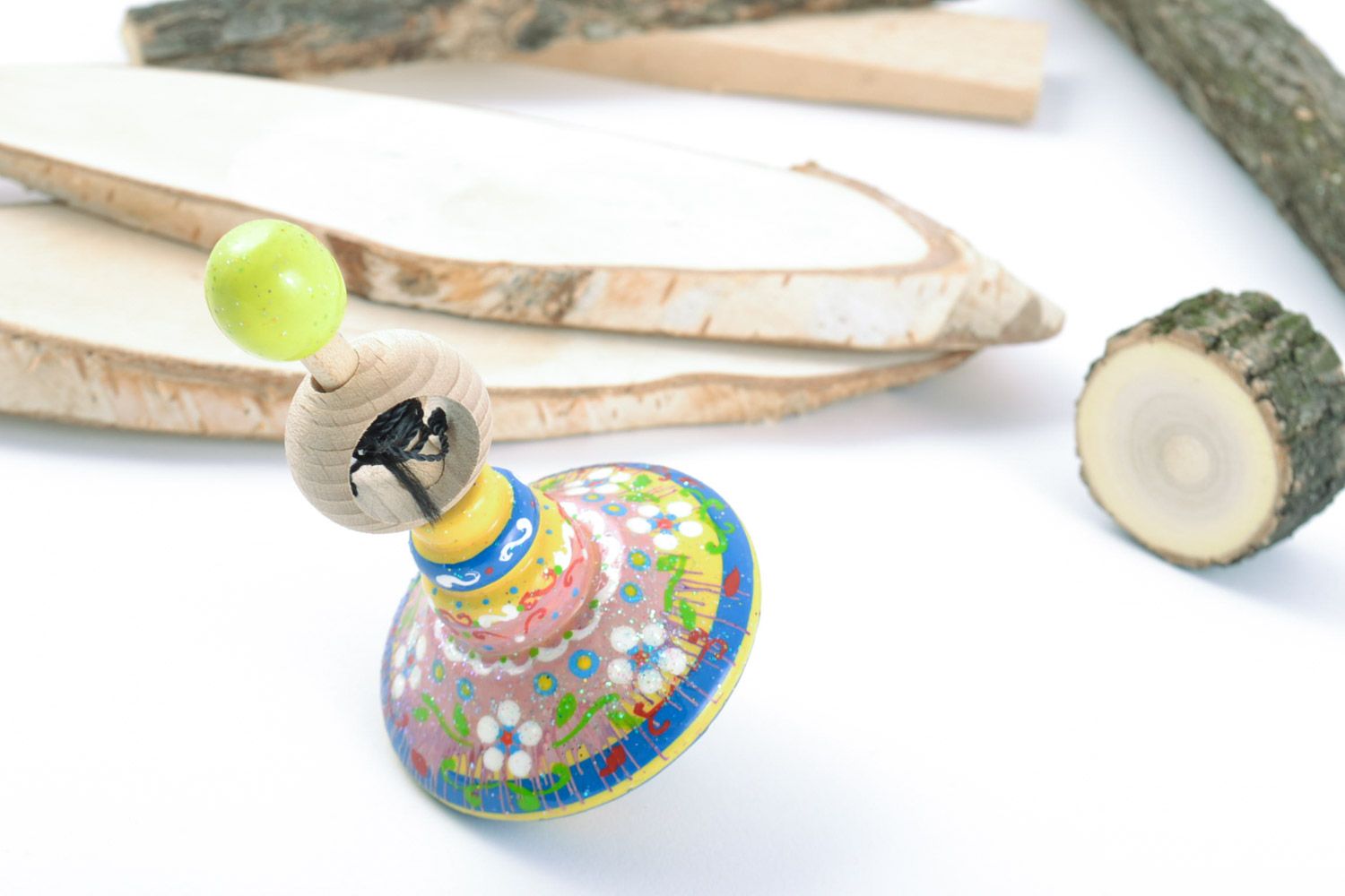 Wooden handmade beautiful spinning top decorated with eco-friendly paints manually photo 1