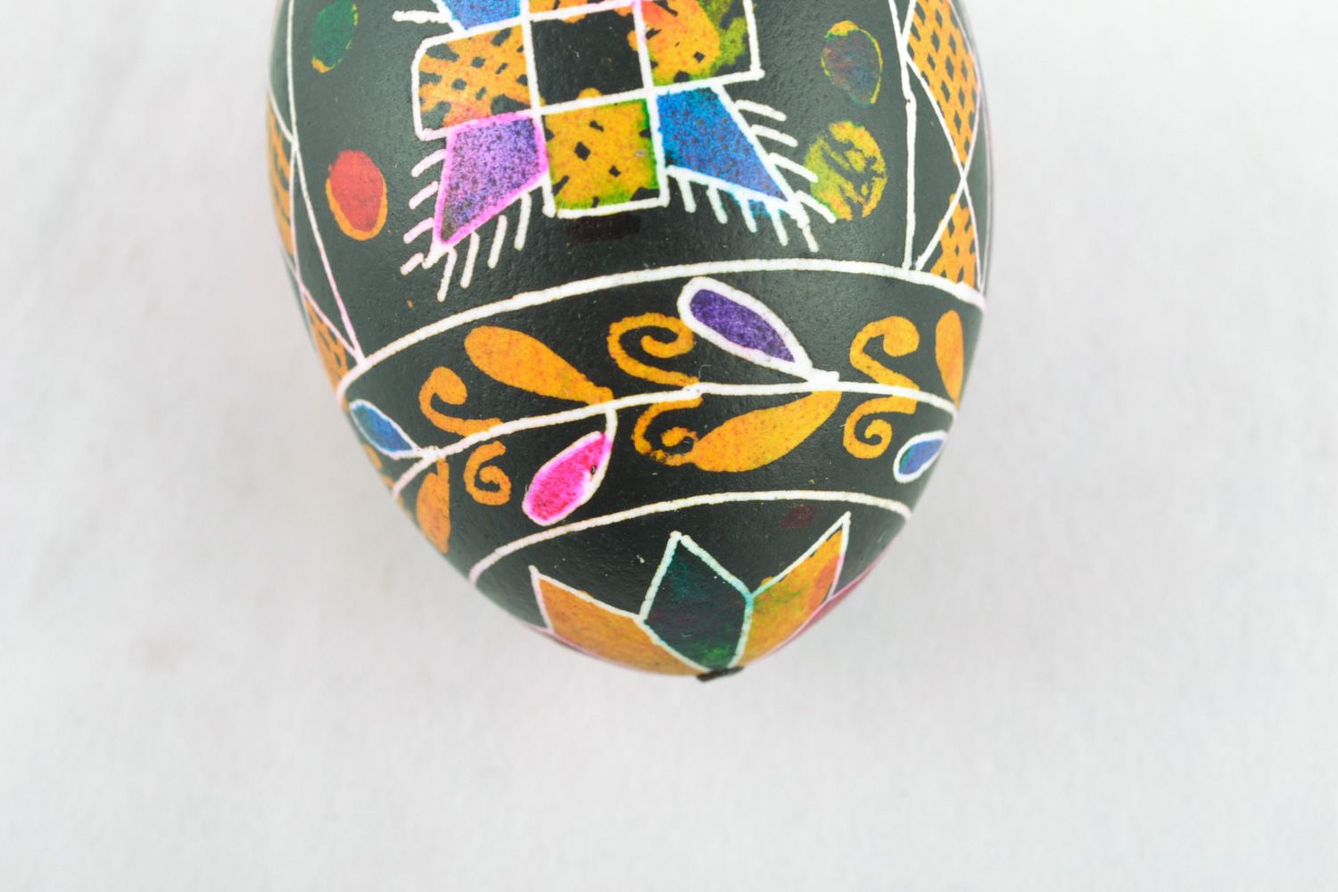 Decorative Easter egg with wax painting of black color with traditional patterns photo 3