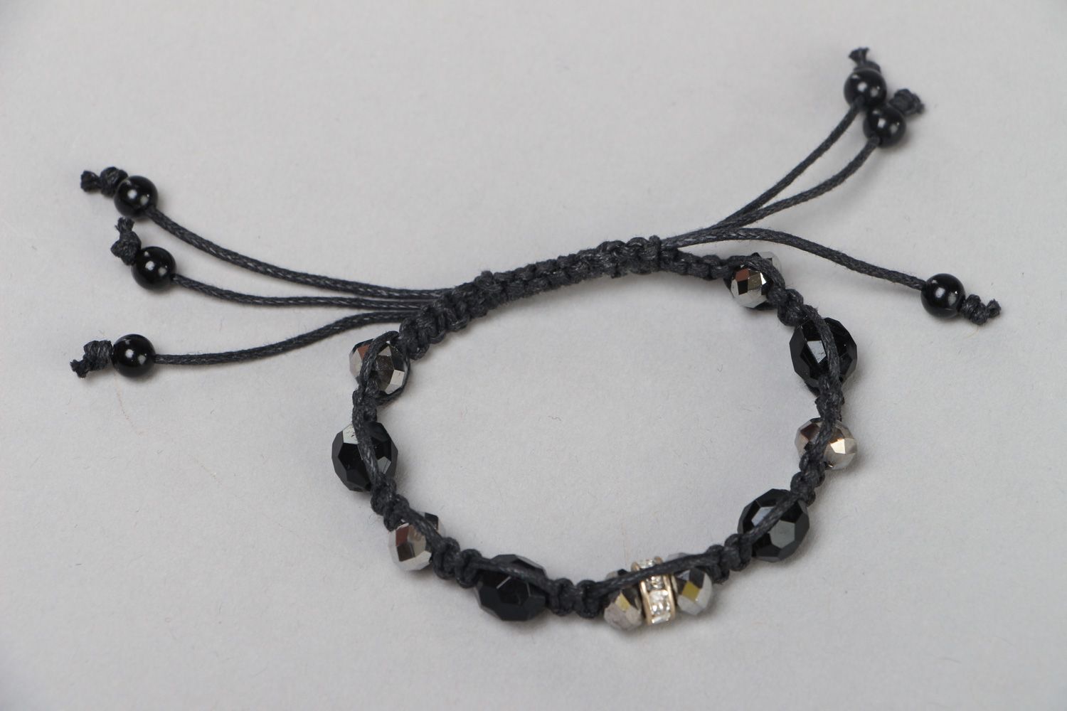 Handmade wrist bracelet woven of waxed cord with glass beads in dark color palette photo 1