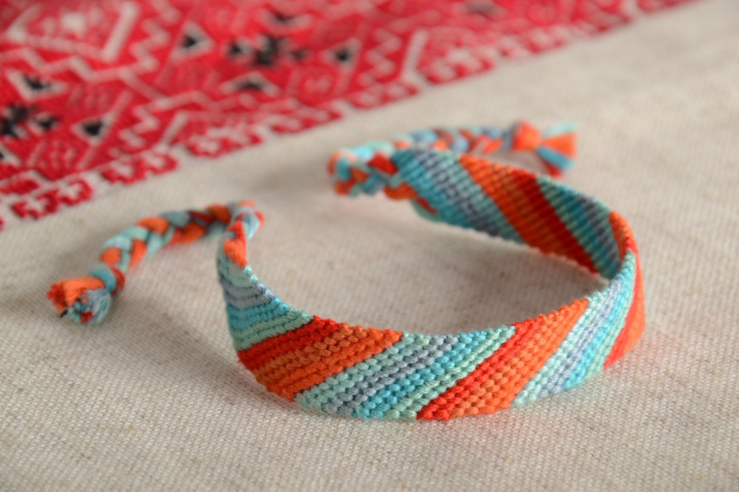 Handmade striped friendship bracelet woven of orange and blue embroidery floss photo 1