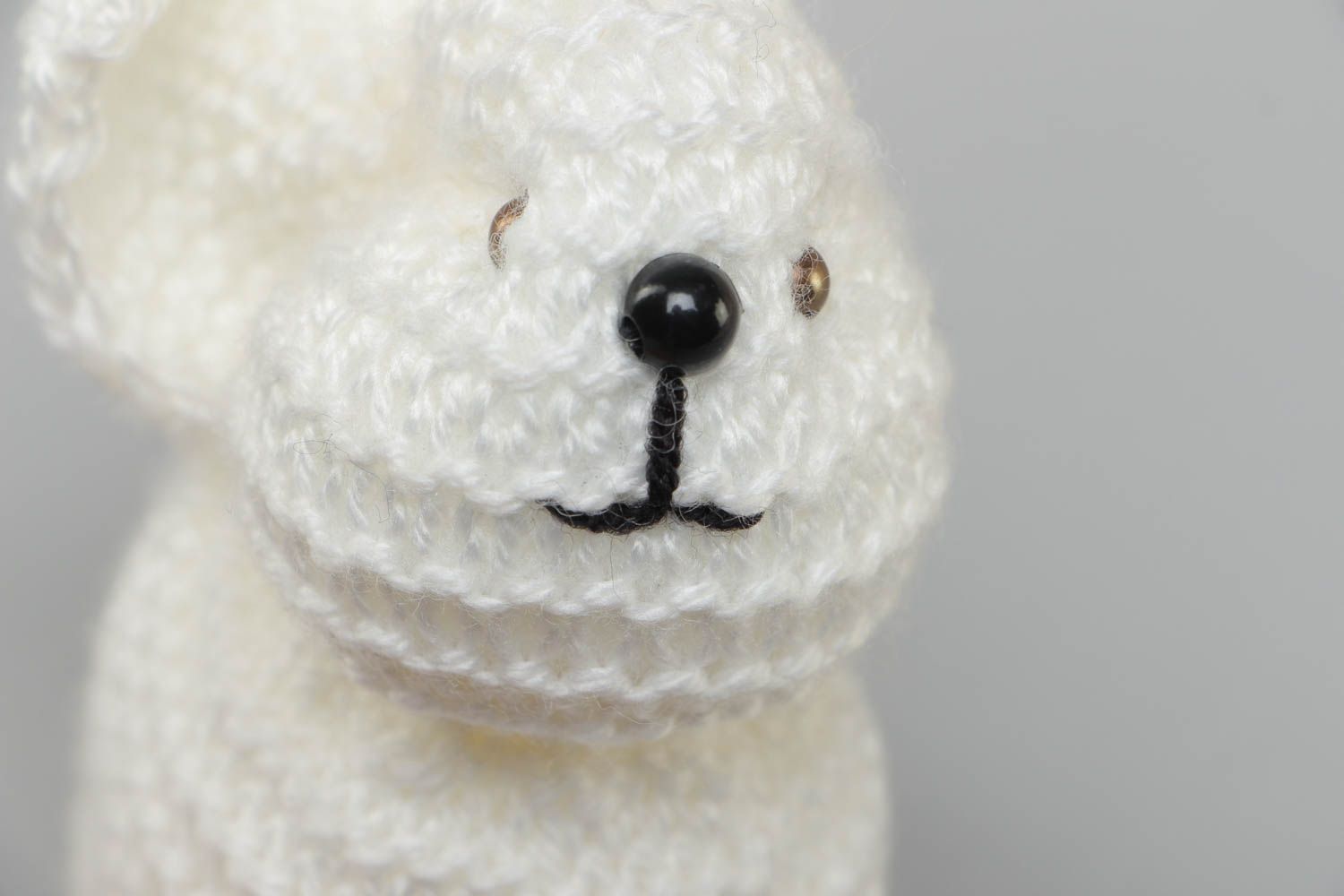 Handmade small soft toy knitted of white acrylic threads in the shape of rabbit photo 3