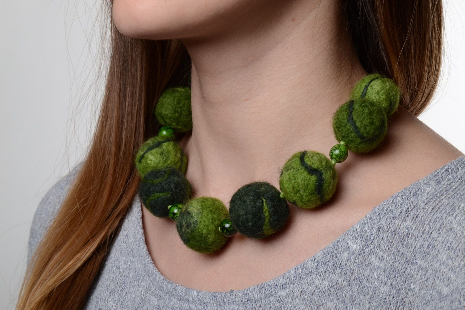 Handmade designer large beaded necklace made of wool using the technique of needle felting in green color photo 1