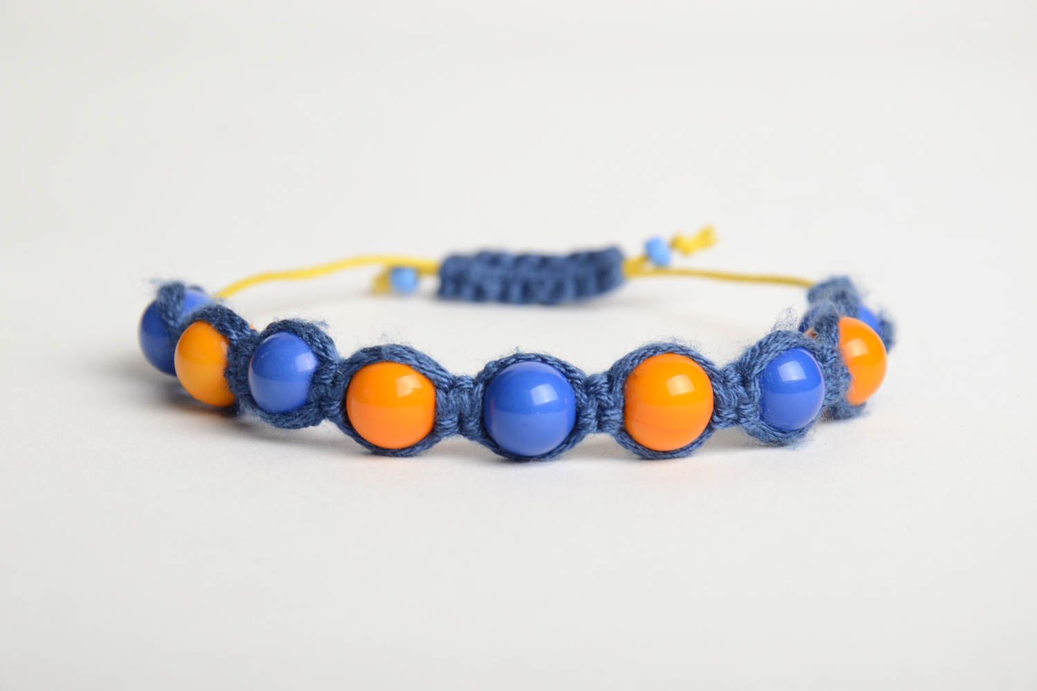 Handmade friendship bracelet woven of blue cord and orange beads for children photo 4