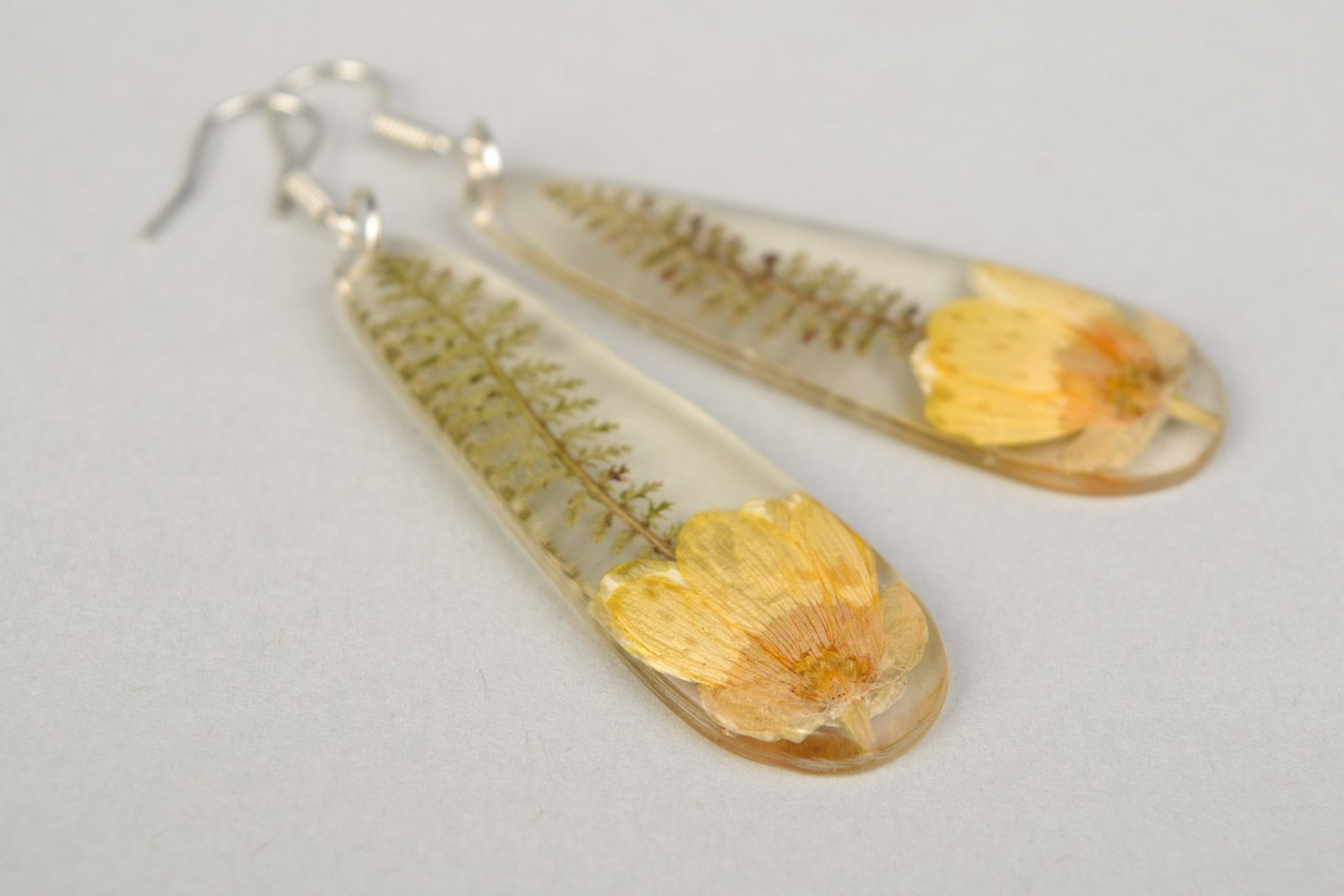Handmade long drop-shaped dangle earrings with yellow-cup flower in epoxy resin photo 4