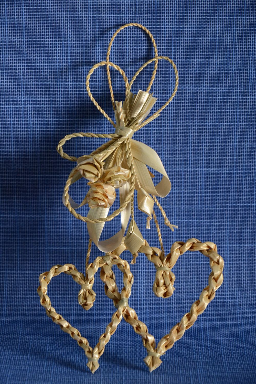 Handmade interior decoration woven of straw in the shape of two hearts photo 1