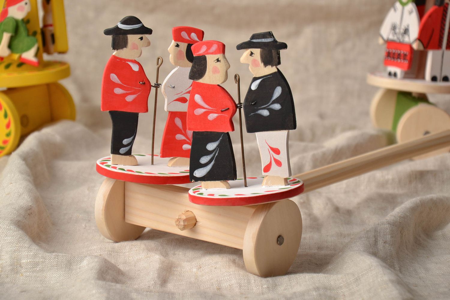 Handmade wooden wheeled toy with ethnic painting photo 1