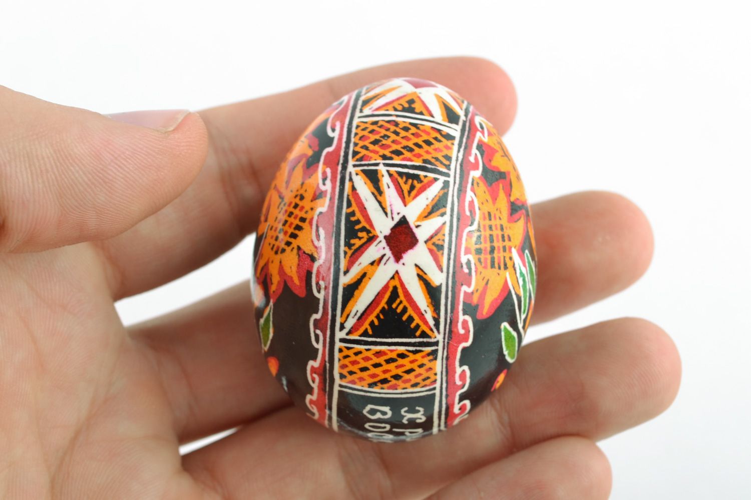 Handmade Easter egg with floral ornament on black background painted with hot wax photo 2