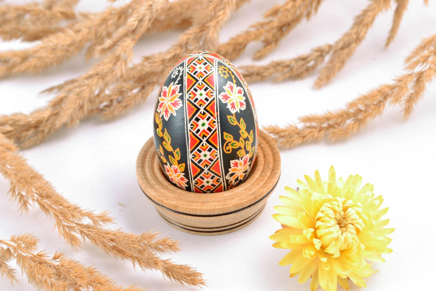 Chicken Easter egg of black color with colorful ornament photo 1
