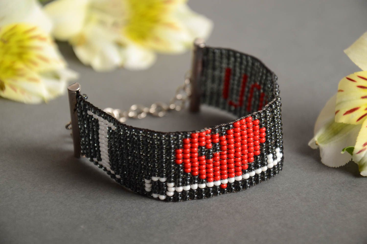 Handmade wide bead woven wrist bracelet with red heart on black background photo 1