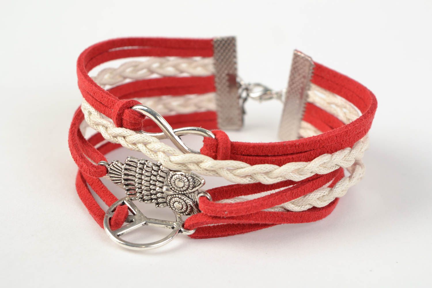 Red handmade woven suede cord bracelet with inserts in the shape of various signs photo 3