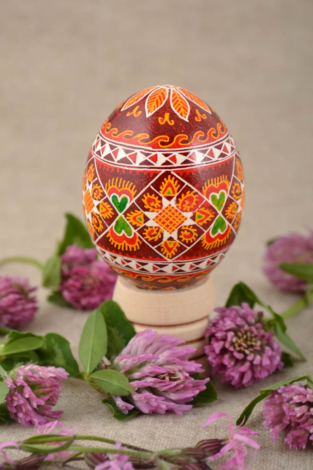 Decorative handmade painted Easter egg with ornament in red color palette photo 1