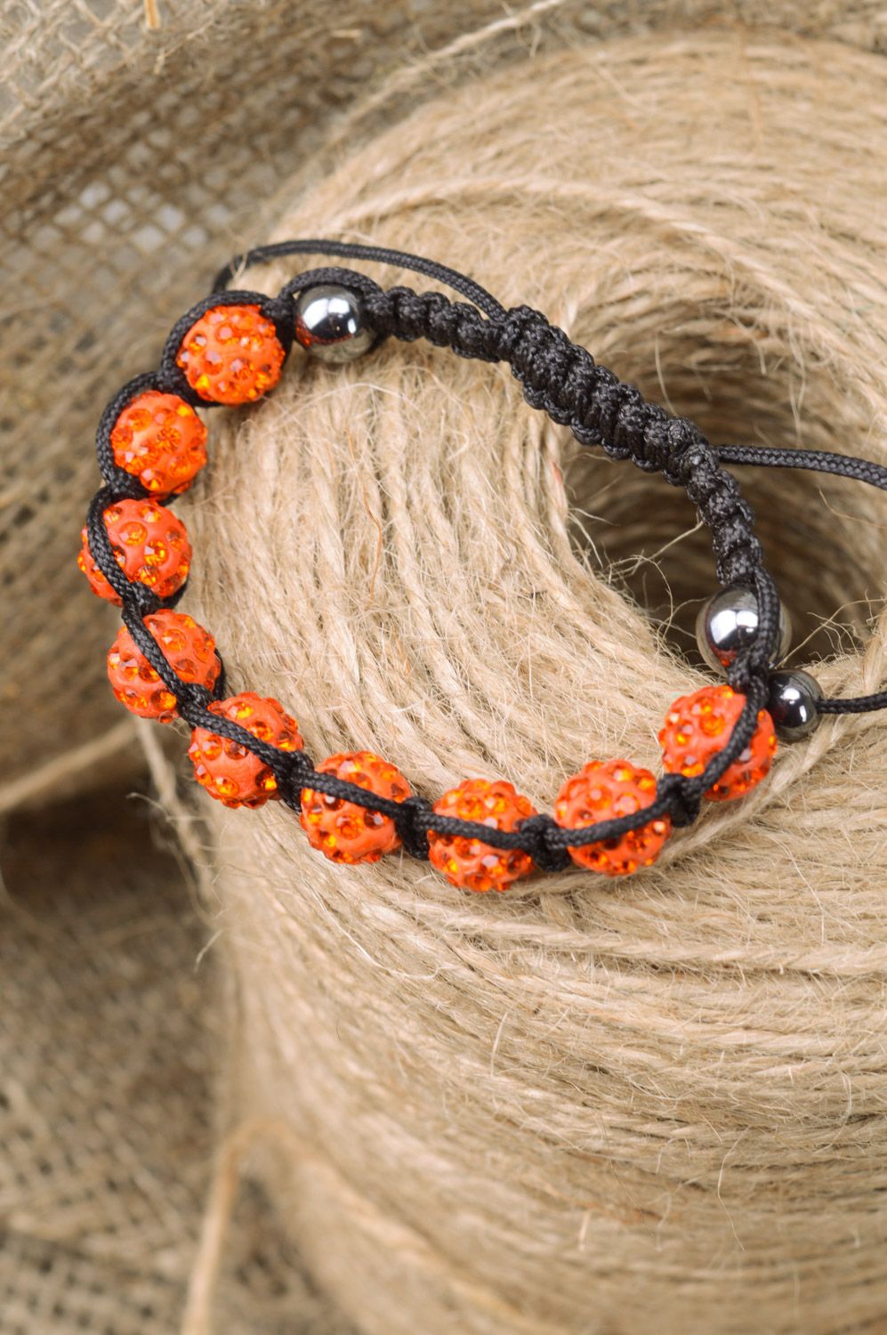 Bright orange handmade wrist bracelet woven of threads and beads with adjustable size photo 1