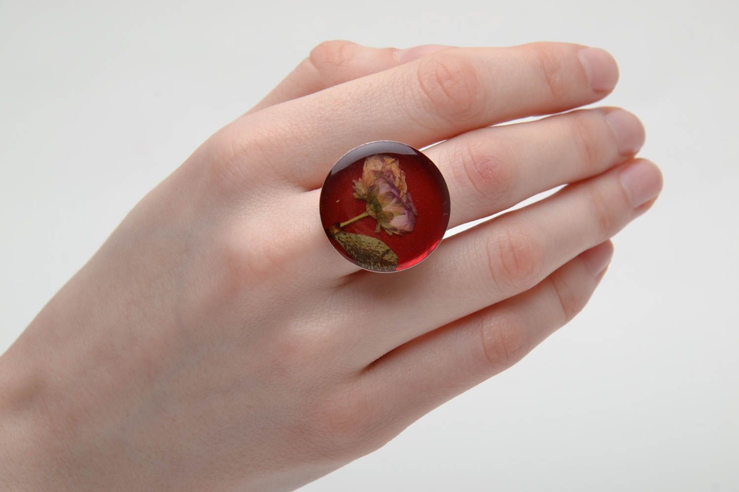 Unusual round ring with natural flower in epoxy resin photo 2