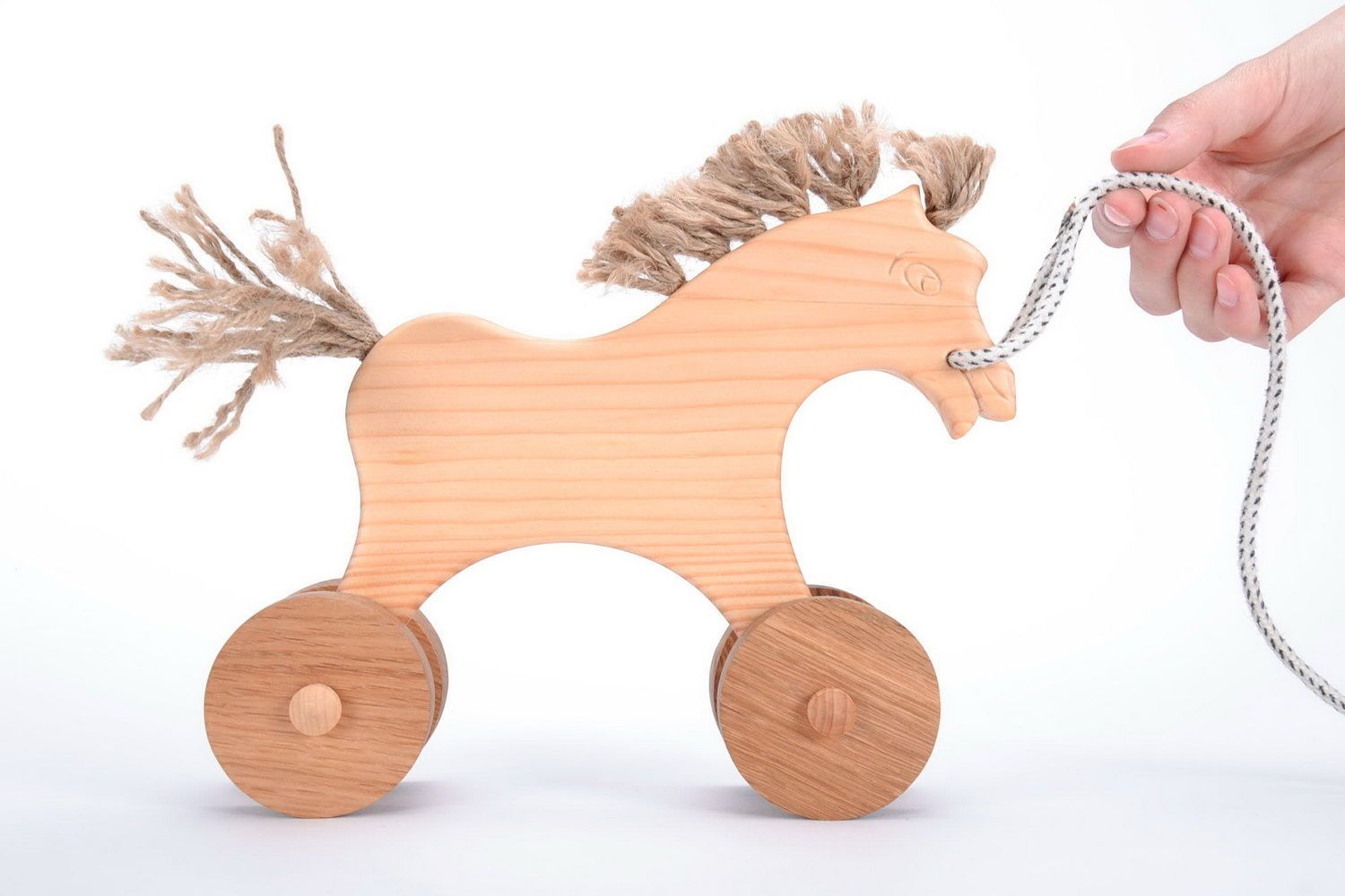 Wooden toy horse on wheels photo 1