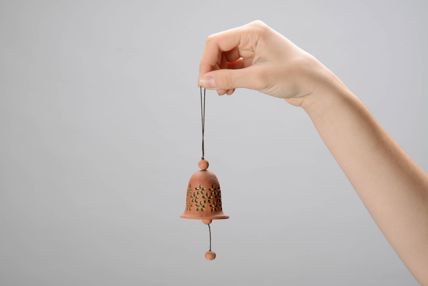 Cast bell made from red clay with stamping photo 2