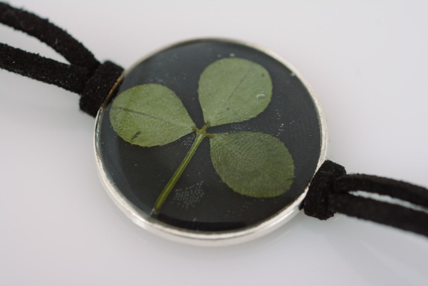 Handmade black wrist bracelet with clover in epoxy resin and leather cord  photo 3