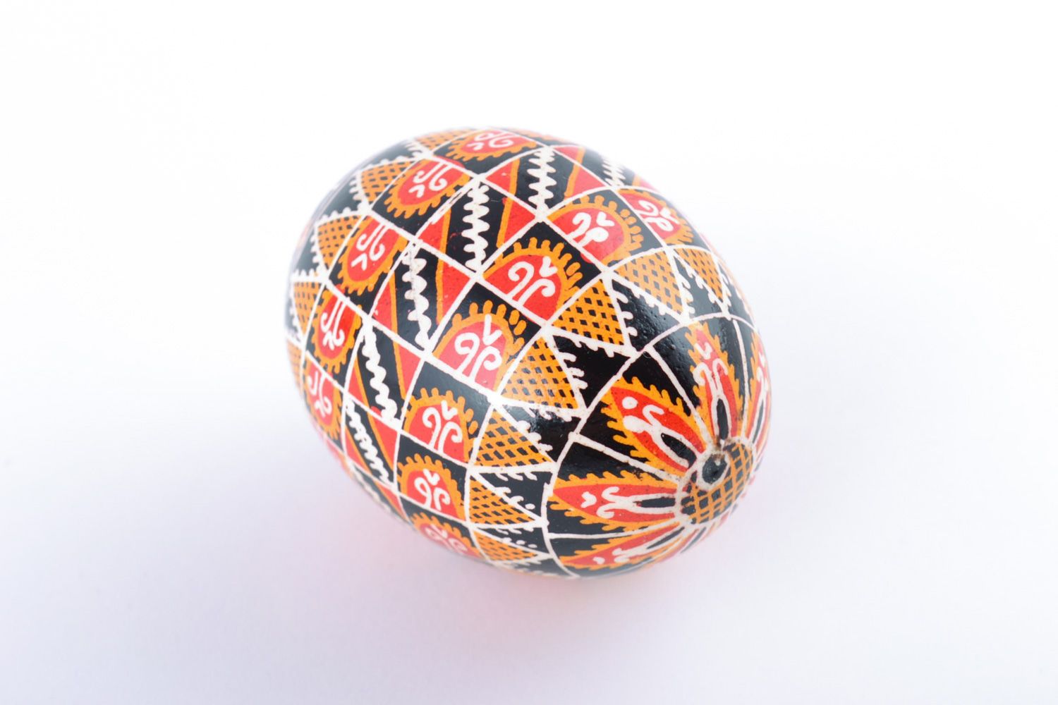 Huevo de Pascua de gallina pintado artesanal con ornamentos en fondo negro foto 4