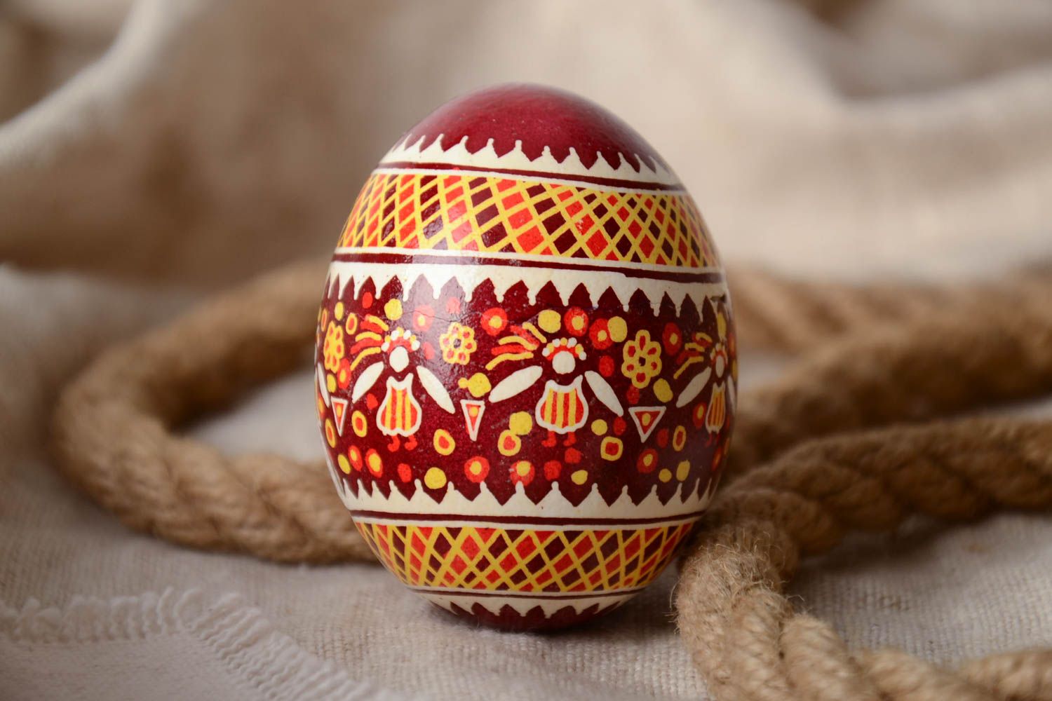 Red and yellow handmade designer painted Easter egg created using waxing technique photo 1